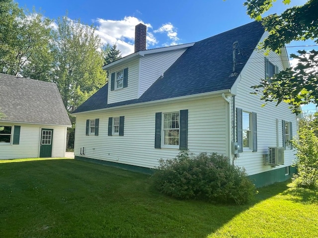 rear view of property with a yard