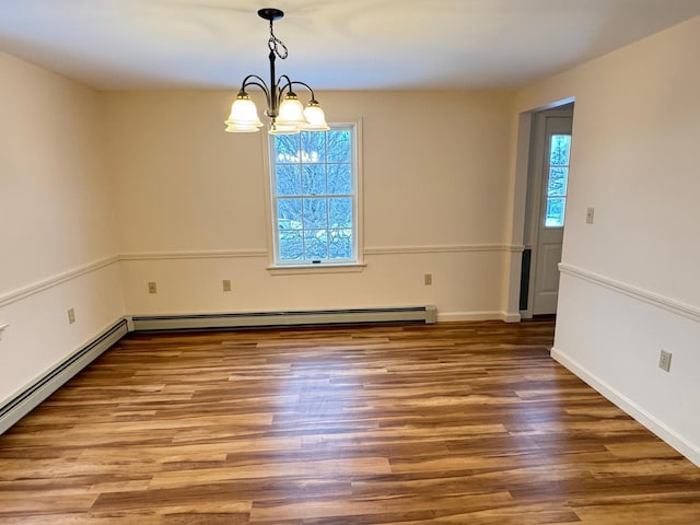 unfurnished dining area with a chandelier, hardwood / wood-style flooring, a baseboard radiator, and plenty of natural light