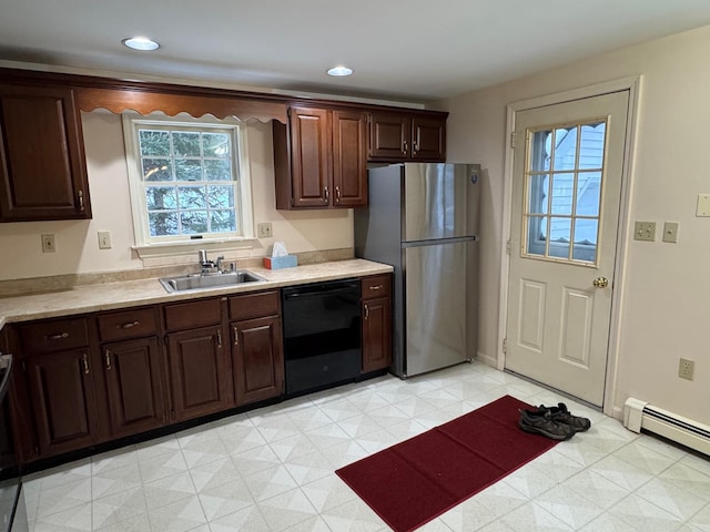 kitchen with a baseboard heating unit, sink, stainless steel fridge, black dishwasher, and dark brown cabinets