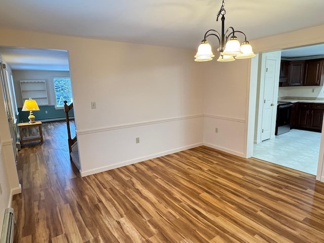 unfurnished dining area with baseboard heating, light hardwood / wood-style flooring, and an inviting chandelier