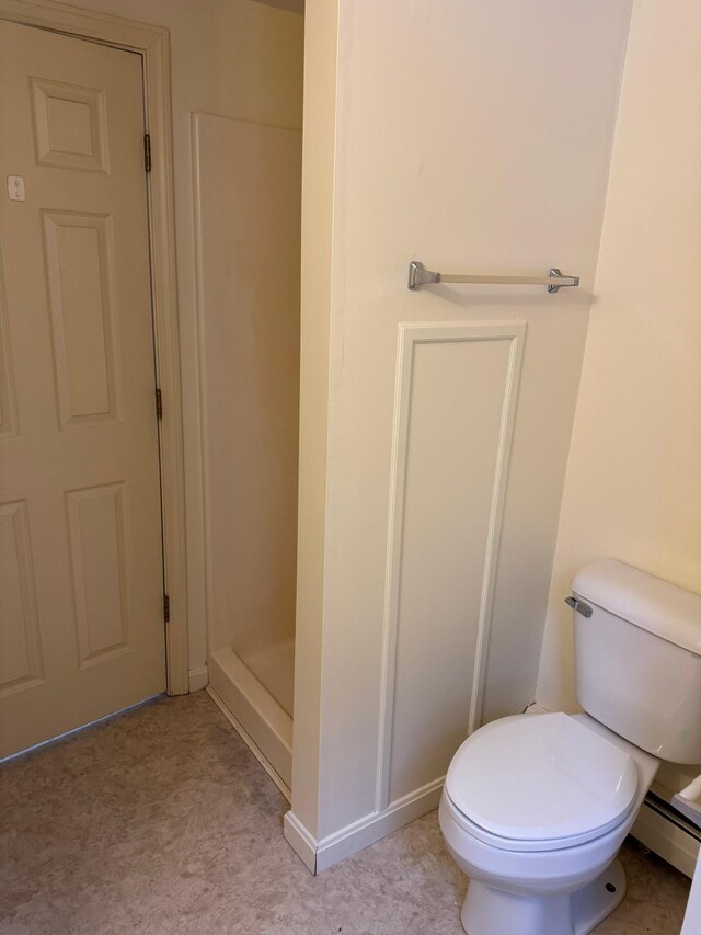 bathroom featuring toilet and a shower