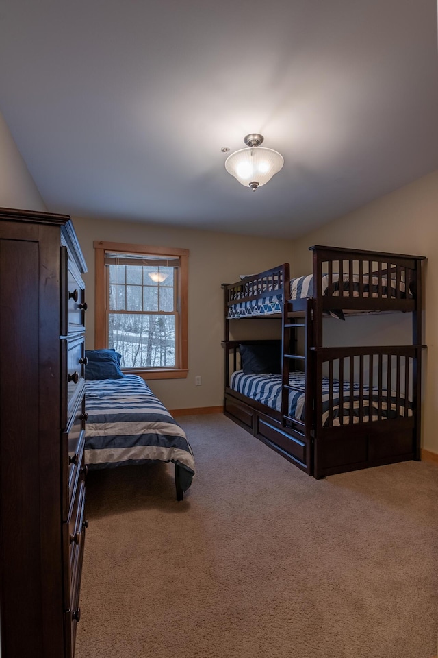 bedroom featuring lofted ceiling and carpet floors