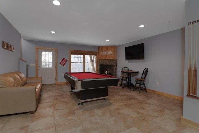 game room featuring pool table and a fireplace