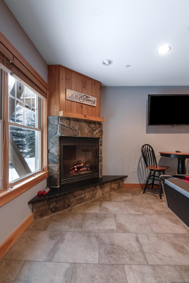 living room featuring a stone fireplace