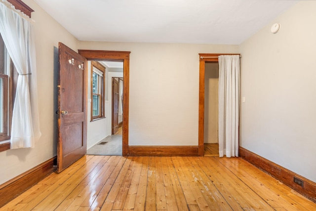 unfurnished room with light wood-type flooring