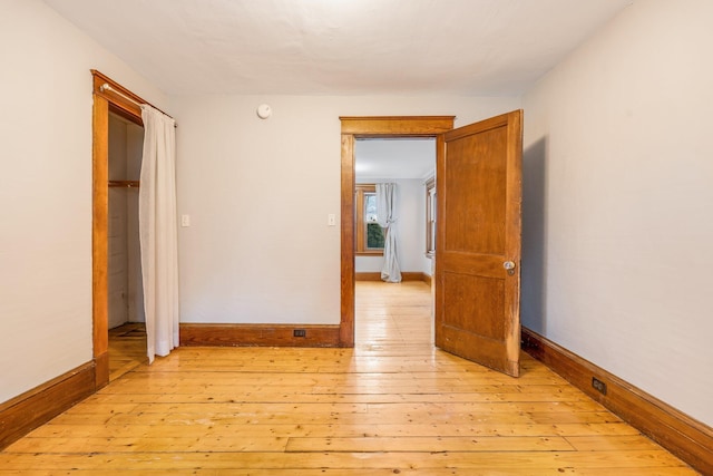 unfurnished bedroom featuring a closet and light hardwood / wood-style flooring