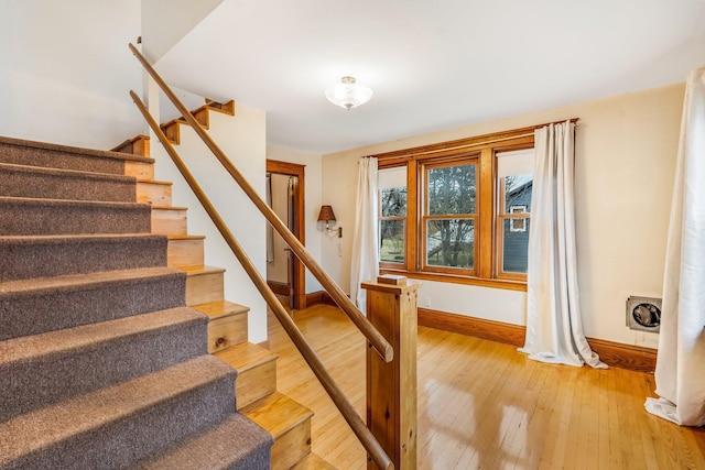 staircase with hardwood / wood-style floors