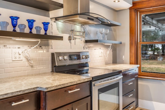 kitchen featuring backsplash, dark brown cabinetry, island exhaust hood, and stainless steel range with electric cooktop