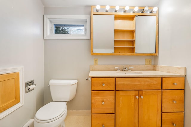 bathroom featuring toilet, tile patterned flooring, and vanity