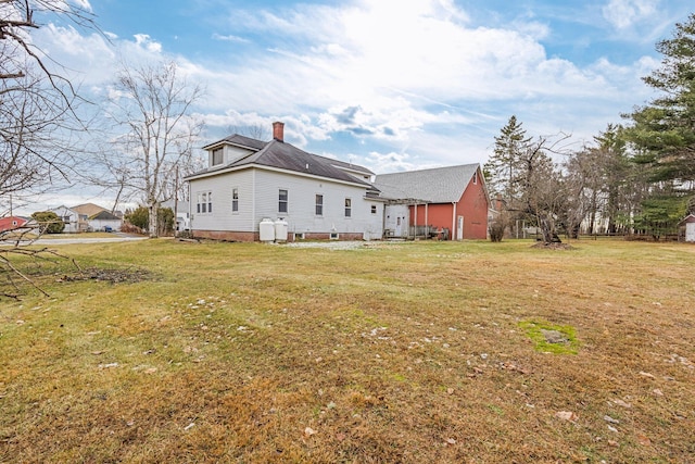 rear view of property with a yard