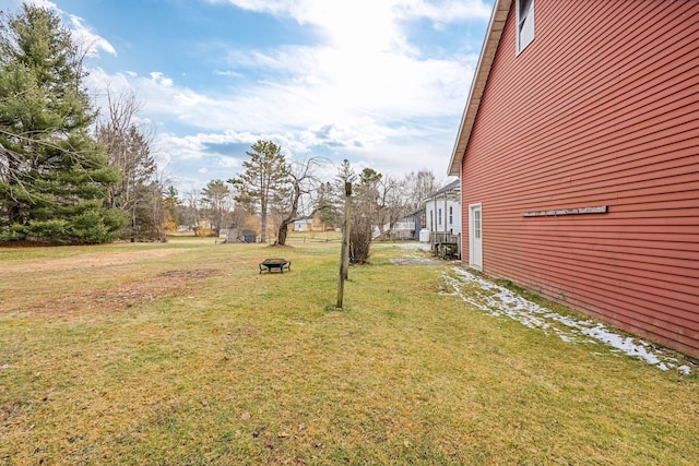 view of yard with a fire pit