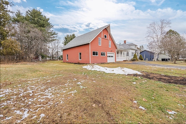 view of home's exterior featuring a garage and a yard