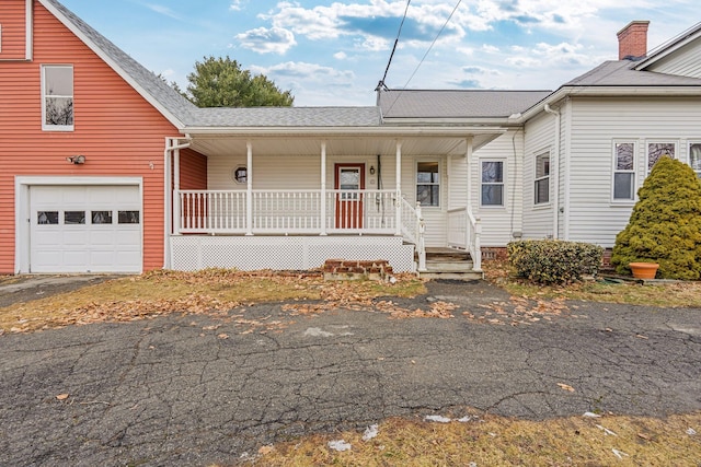 view of front facade with a garage and covered porch