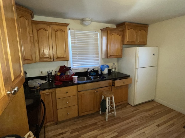 kitchen with sink, white fridge, and light hardwood / wood-style floors