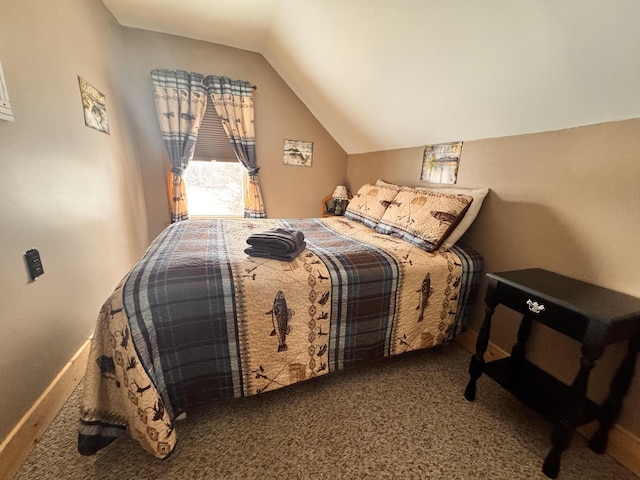 bedroom with carpet floors and lofted ceiling