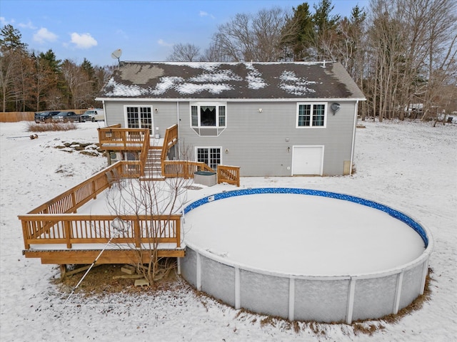 snow covered property featuring a wooden deck