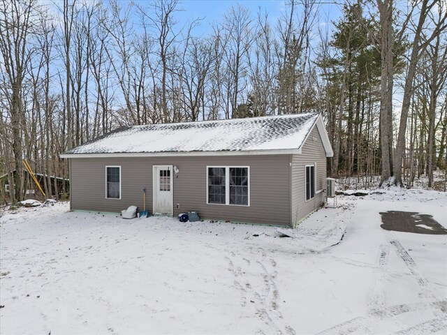 snow covered back of property with central air condition unit