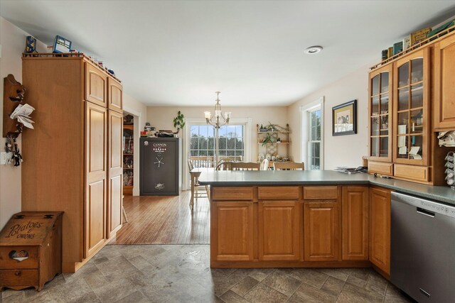 kitchen with pendant lighting, hardwood / wood-style floors, stainless steel dishwasher, kitchen peninsula, and a chandelier