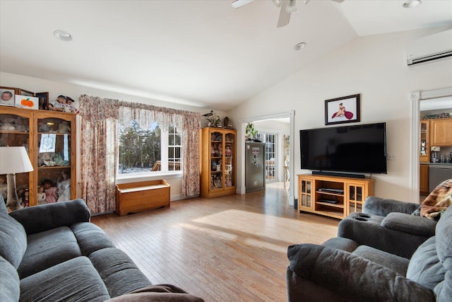 living room with a wall mounted AC, ceiling fan, vaulted ceiling, and light wood-type flooring