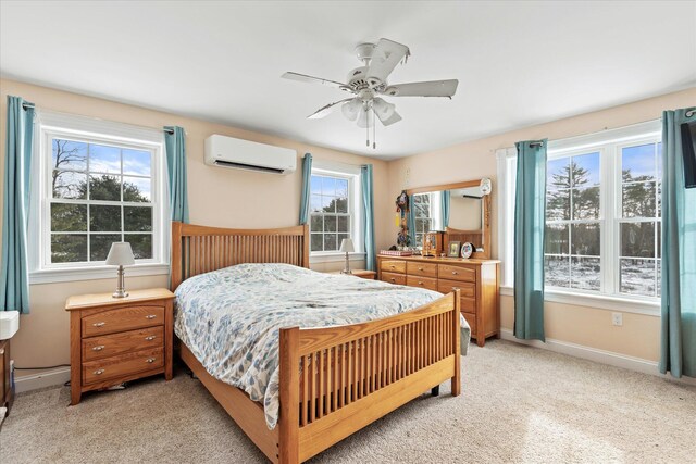 carpeted bedroom featuring a wall mounted air conditioner, ceiling fan, and multiple windows