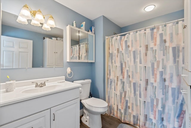 bathroom featuring a shower with curtain, vanity, toilet, and hardwood / wood-style floors