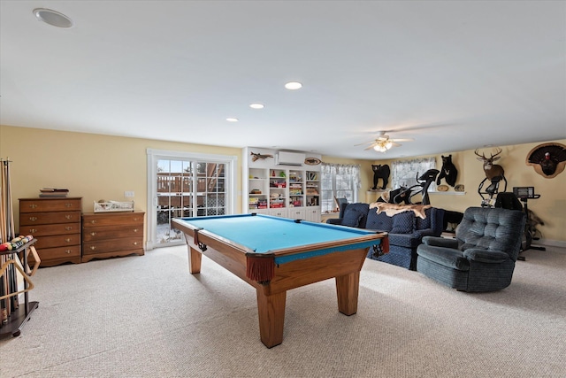 game room with a wall mounted AC, ceiling fan, light colored carpet, and billiards