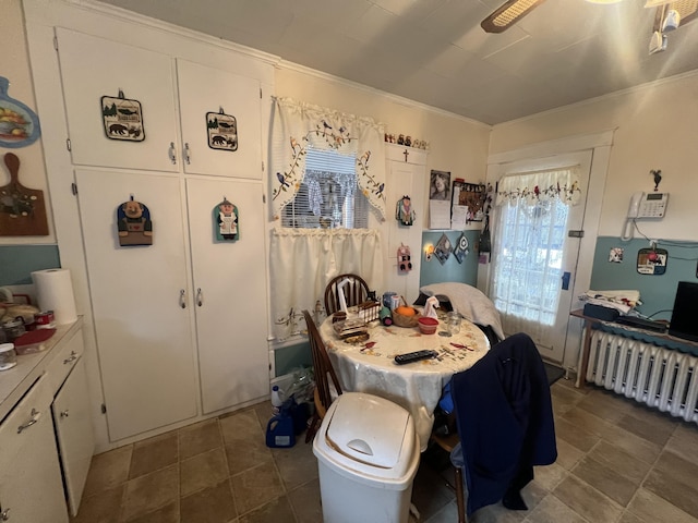 dining space featuring ornamental molding, ceiling fan, and radiator heating unit