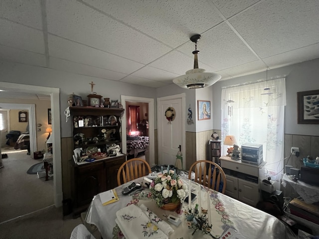 dining space featuring a drop ceiling