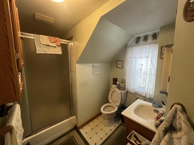 bathroom with toilet, vaulted ceiling, and vanity