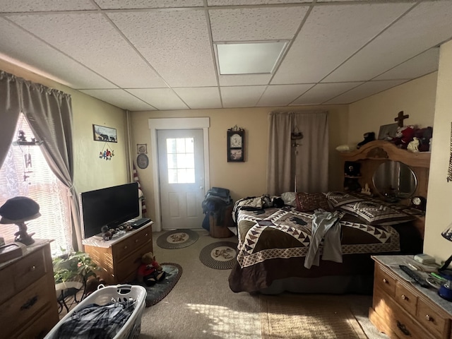 carpeted bedroom with a drop ceiling