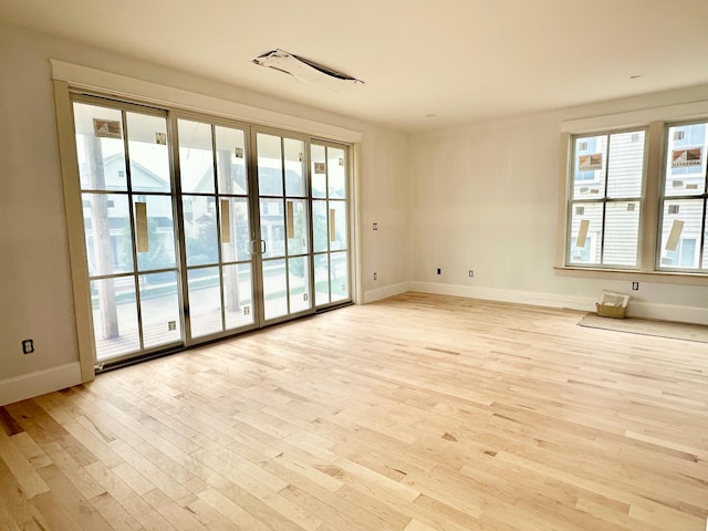 unfurnished room featuring light hardwood / wood-style floors