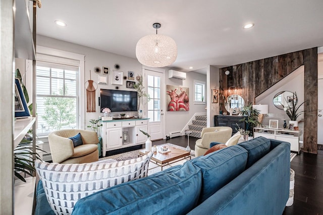 living room featuring dark hardwood / wood-style flooring, an AC wall unit, and a baseboard heating unit