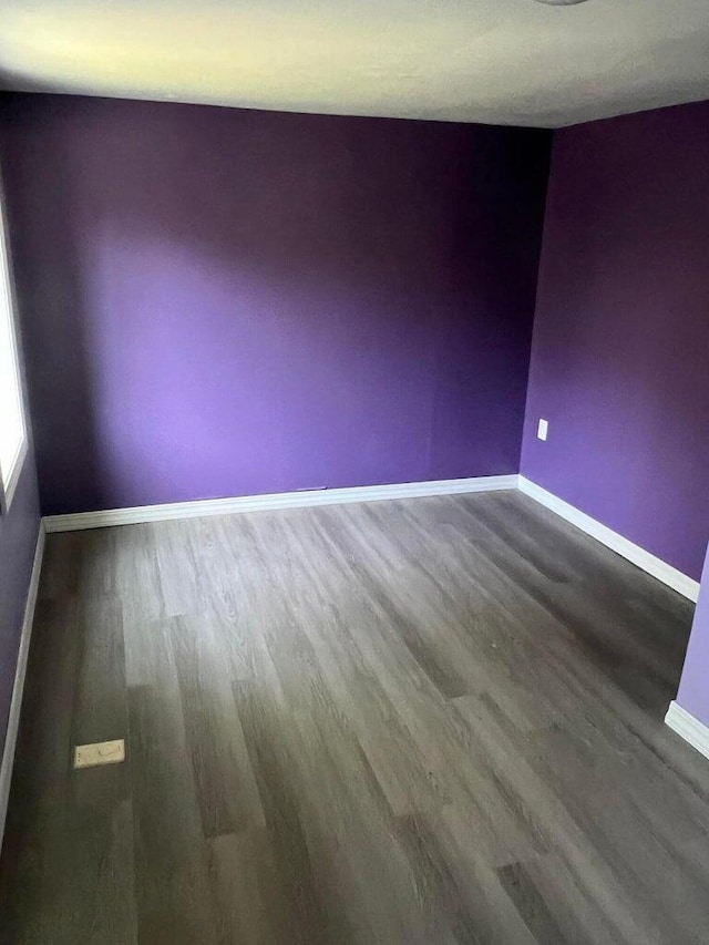 unfurnished room with hardwood / wood-style floors