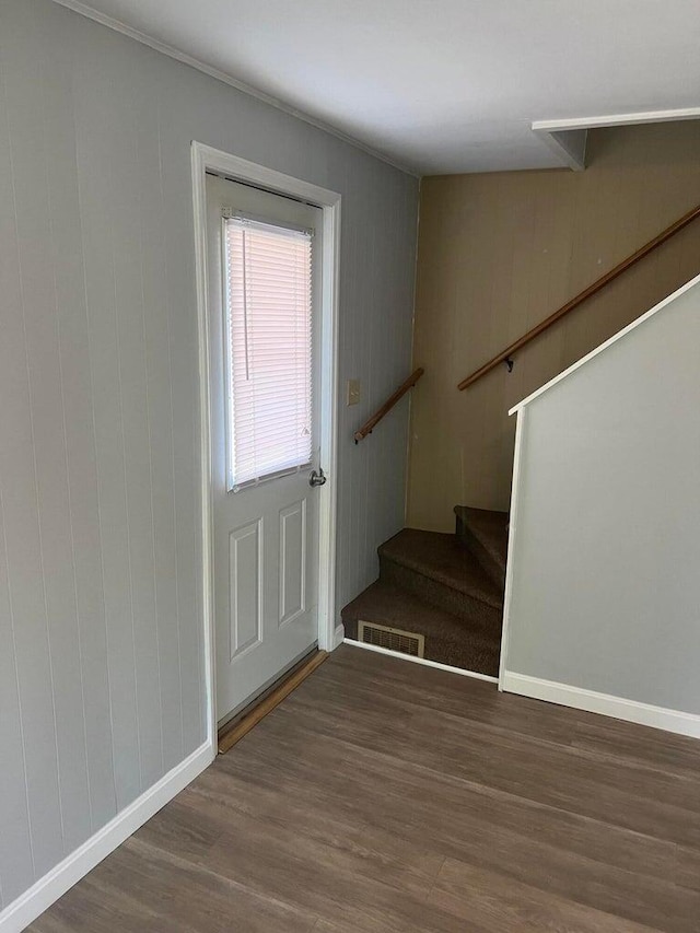 stairs featuring wood-type flooring