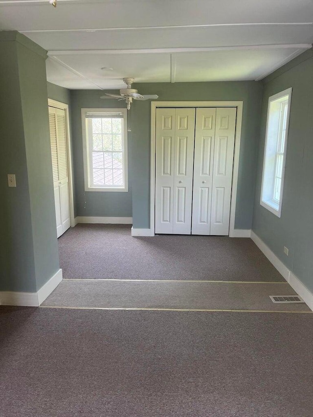 unfurnished bedroom featuring ceiling fan and carpet floors