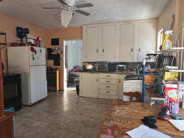 kitchen with black appliances, ceiling fan, and cream cabinetry