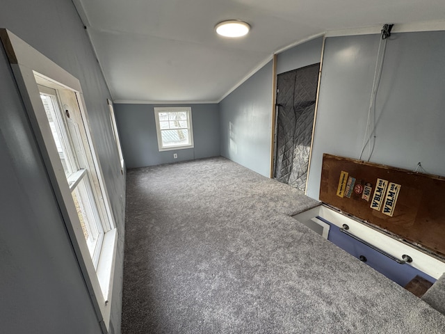 unfurnished living room featuring carpet flooring and lofted ceiling