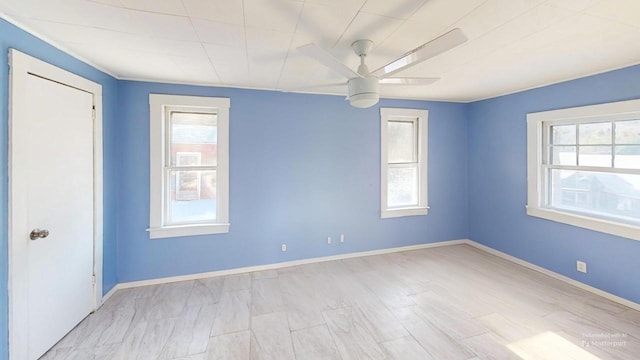 spare room featuring plenty of natural light and ceiling fan