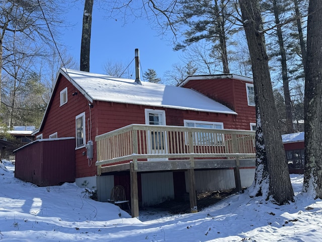 snow covered property featuring a deck