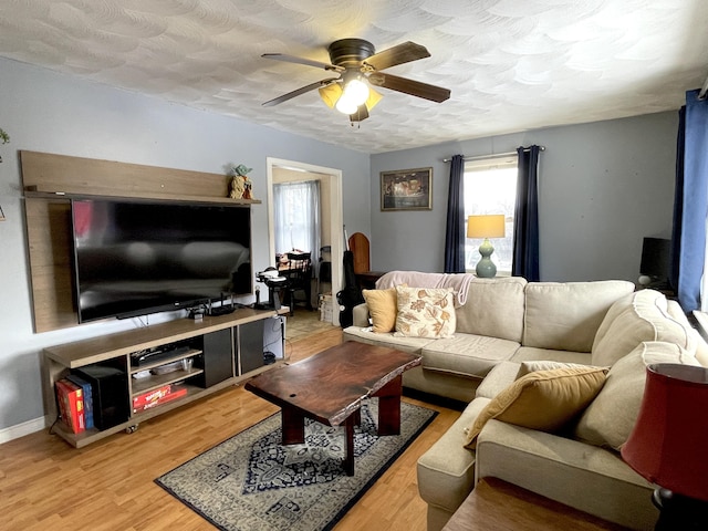 living room featuring hardwood / wood-style flooring, a textured ceiling, and ceiling fan