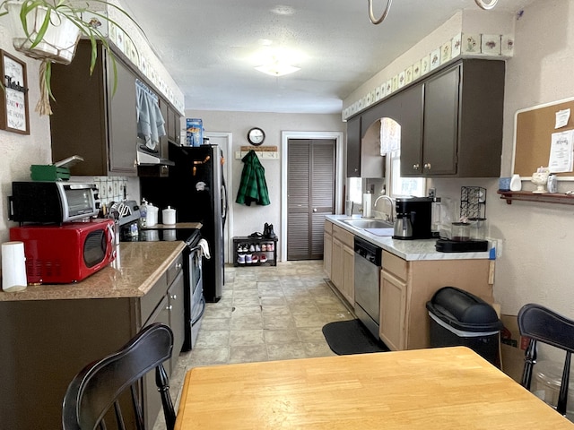 kitchen with appliances with stainless steel finishes and sink