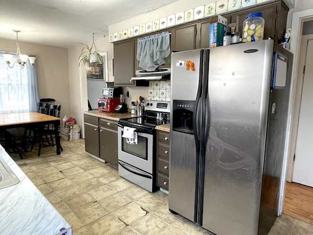 kitchen with hanging light fixtures, appliances with stainless steel finishes, backsplash, and an inviting chandelier