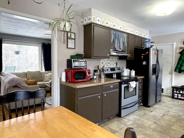 kitchen with appliances with stainless steel finishes and a textured ceiling