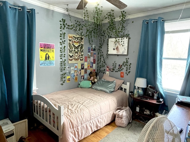 bedroom featuring ornamental molding, hardwood / wood-style floors, and ceiling fan