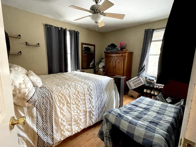 bedroom with light hardwood / wood-style floors and ceiling fan