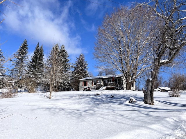 snowy yard with covered porch