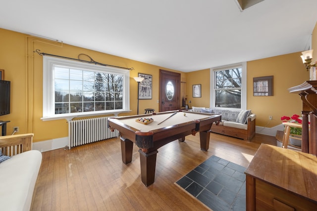 playroom featuring radiator heating unit, light hardwood / wood-style floors, and pool table