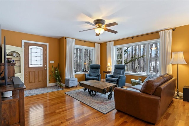 living room featuring ceiling fan and light hardwood / wood-style floors