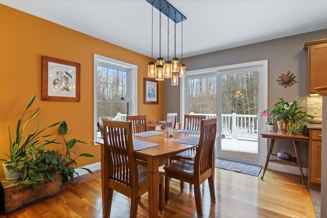 dining room featuring an inviting chandelier and light hardwood / wood-style floors