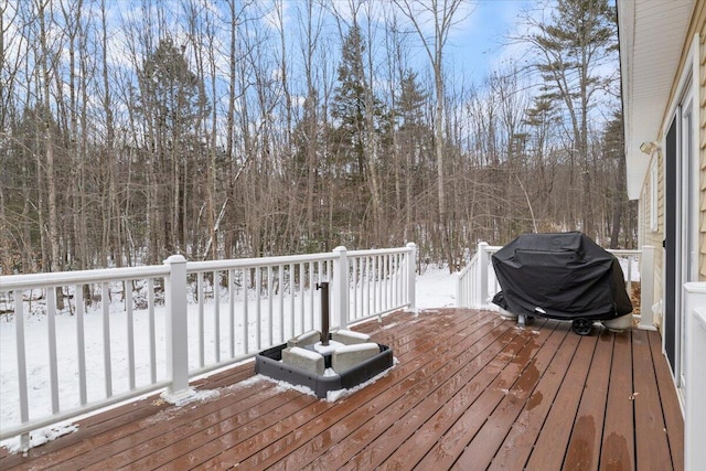 snow covered deck with a grill